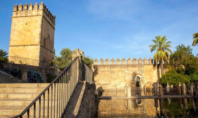 Alcázar de los Reyes Cristianos in Córdoba, Spain, featuring the Tower of the Lions and the reflecting pools of its gardens.