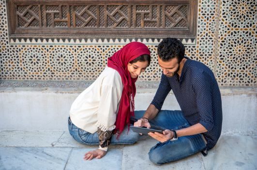 Muslim couple planning a trip to Spain together