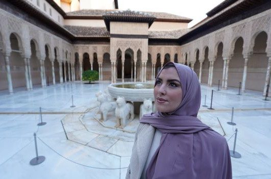 Muslim visitor in the Court of the Lions at the Alhambra in Granada
