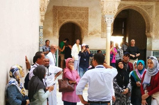 Guide explaining the Alhambra to a group of Malaysian tourists